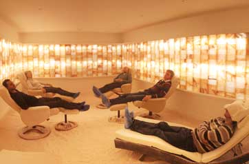 people lying on loungers in a room